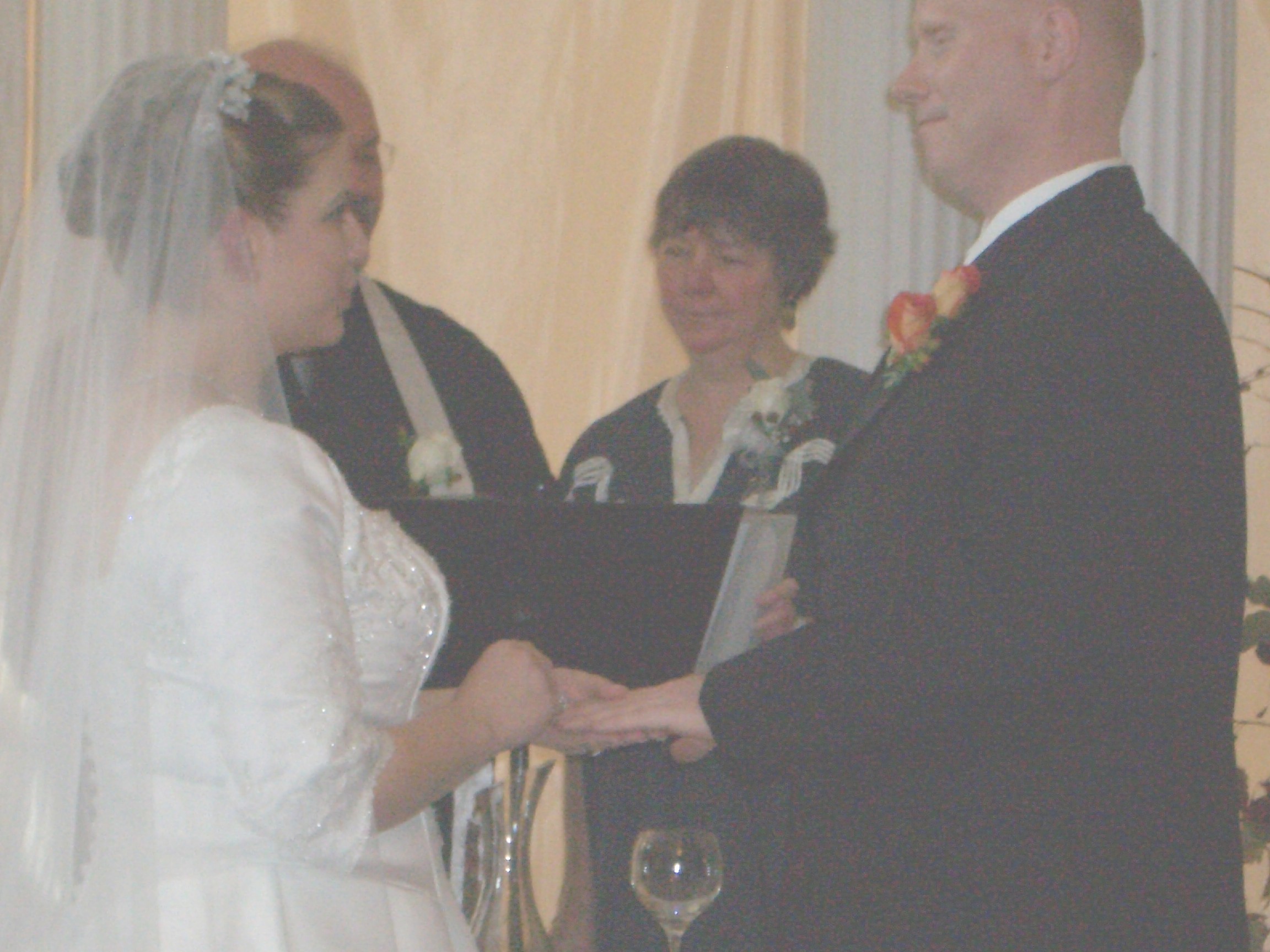 Marie placing John's ring on his finger ...